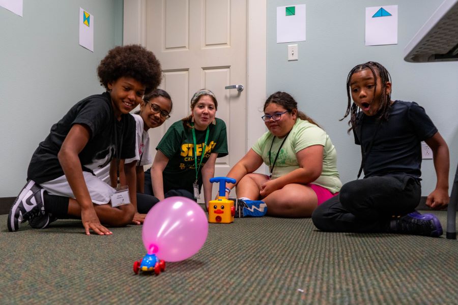STEM+ Camp Launch campers learned about force and friction by launching balloon-powered cars after pumping the balloon full of air.