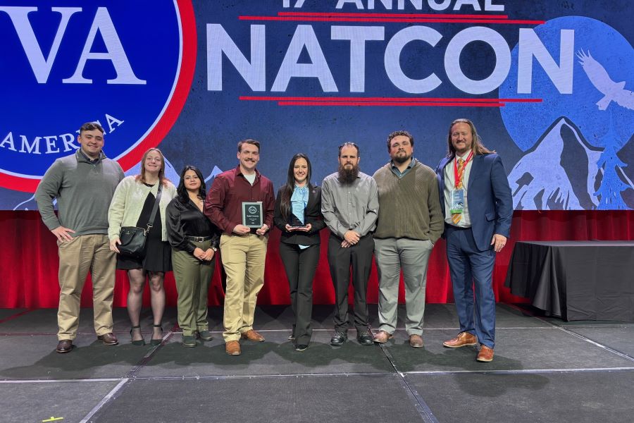 Eight students with the Veterans of Baylor hold an award