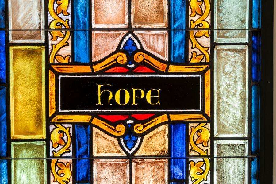 The word Hope in colorful stained glass.