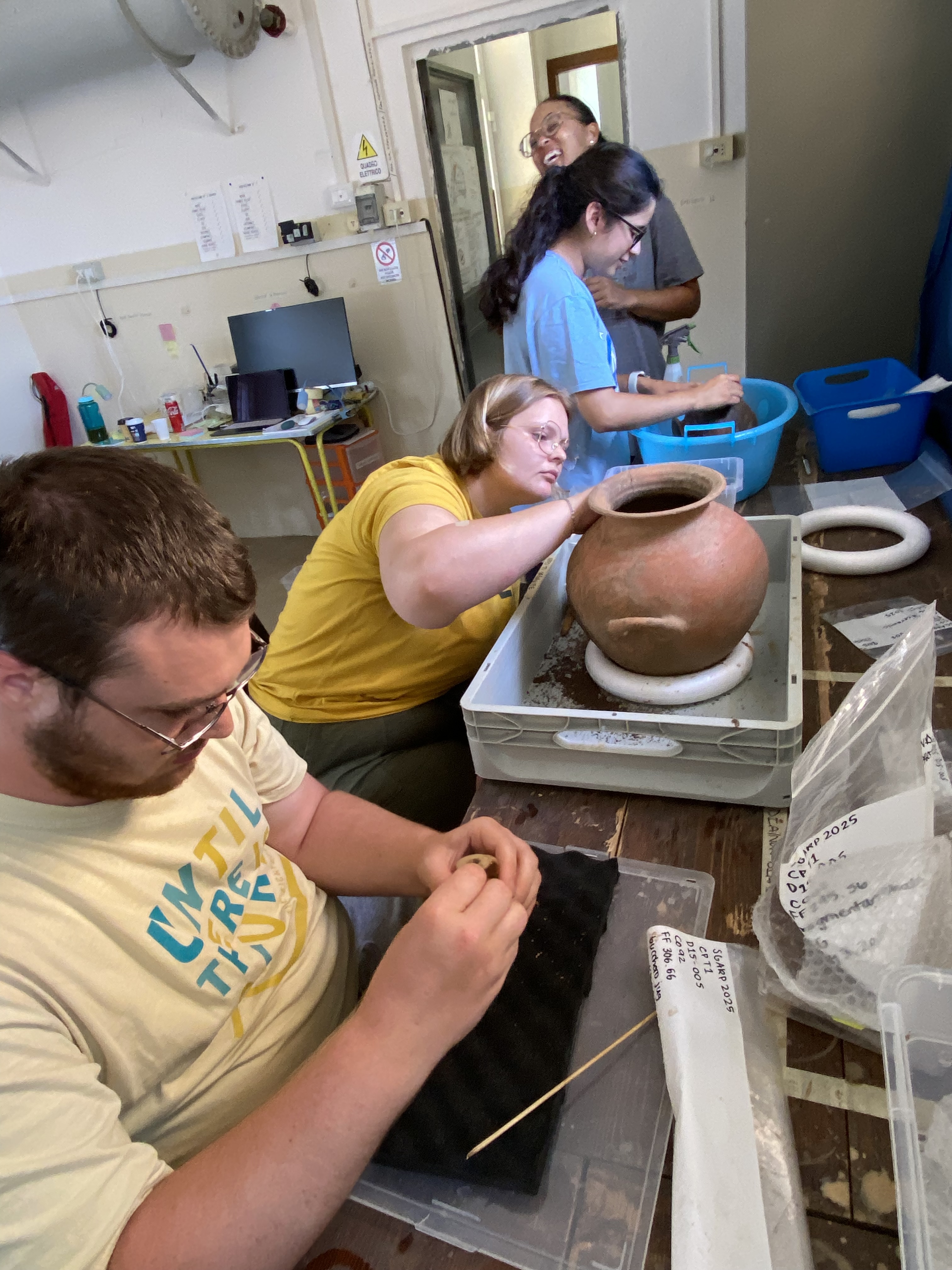 Students cleaning vessels recovered from 7th century BC Etruscan tomb