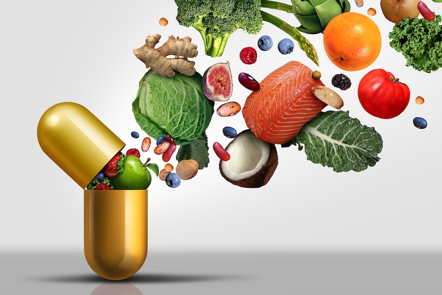 creative image of healthy foods coming out of a gold medicine capsule
