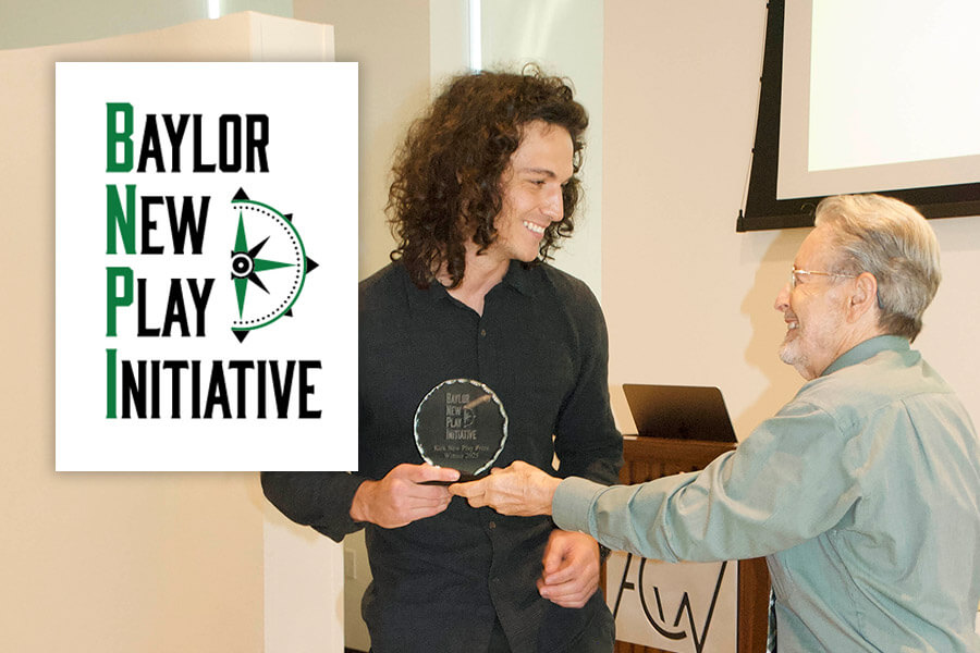a man hands another man and an award