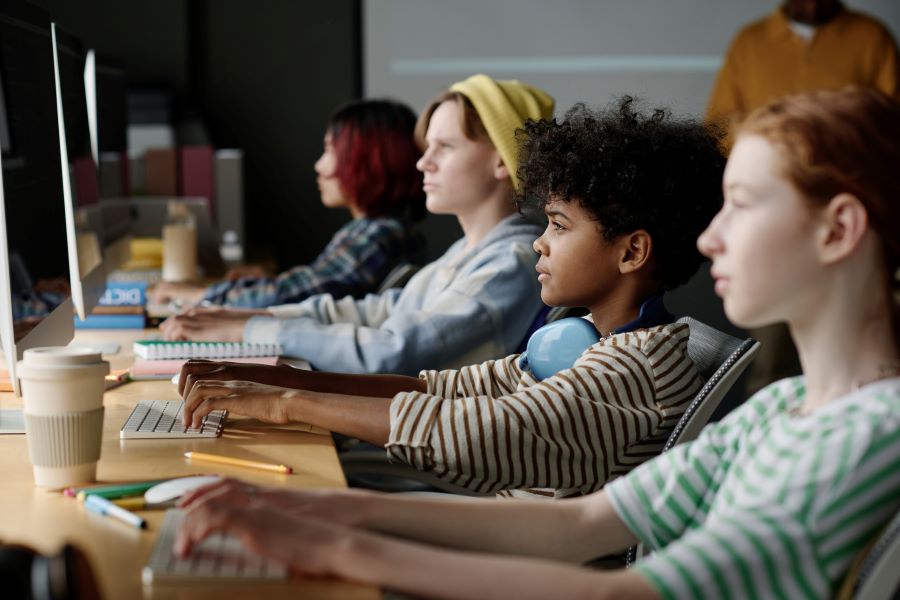 Group of Kids Coding On Computers In Class 