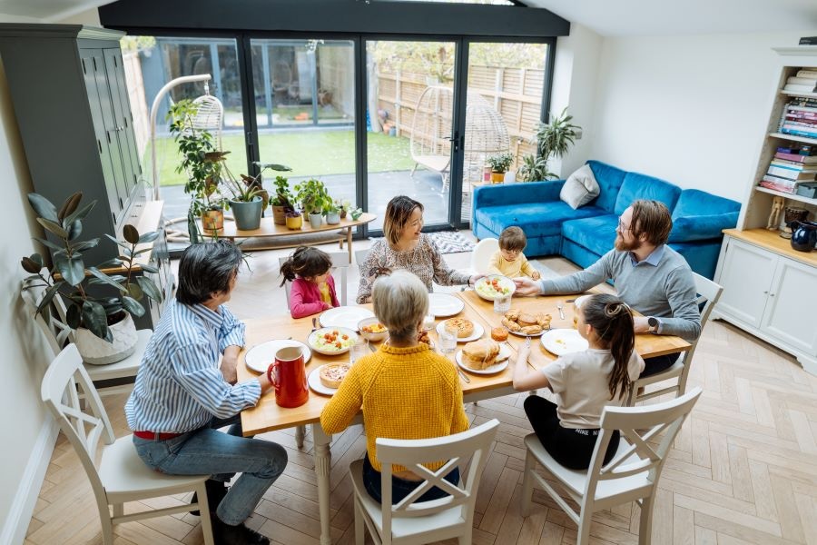 Family sitting around dinner table talking