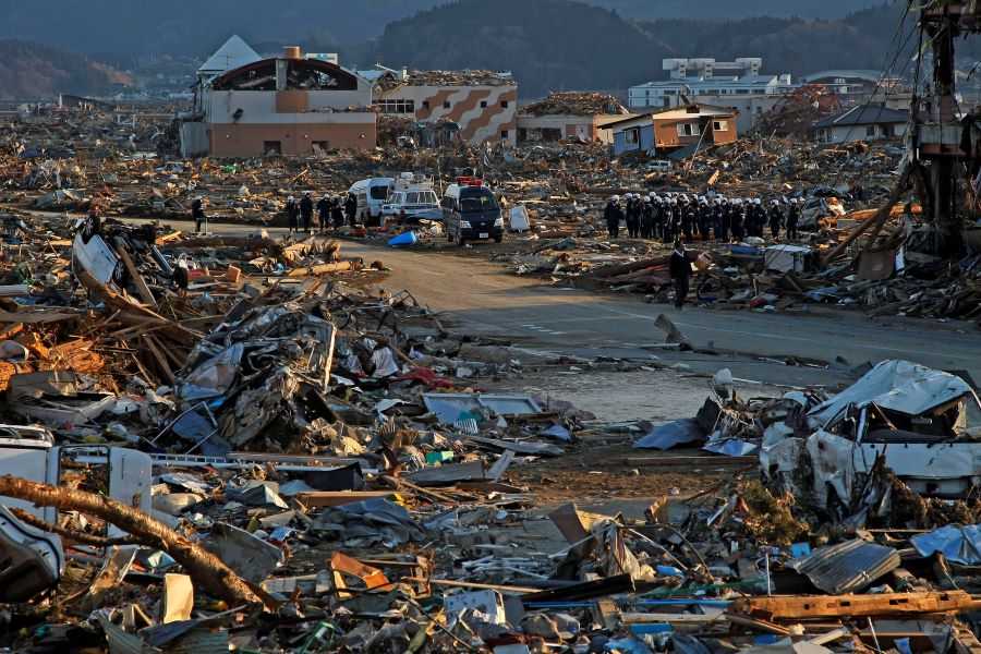 Debris and mud cover a destroyed city in Japan after a 9.0 magnitude earthquake caused a tsunami