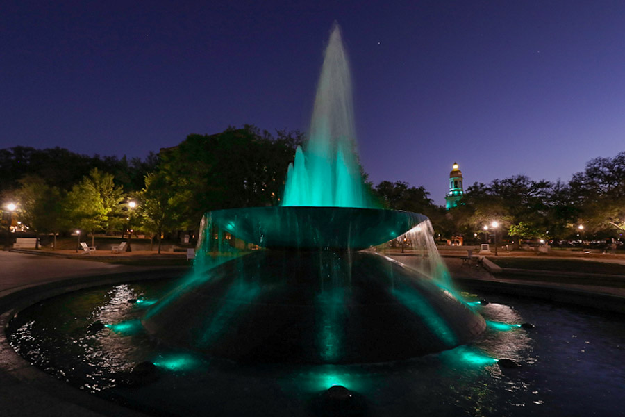Rosenbalm Fountain on Baylor campus lit up teal at night