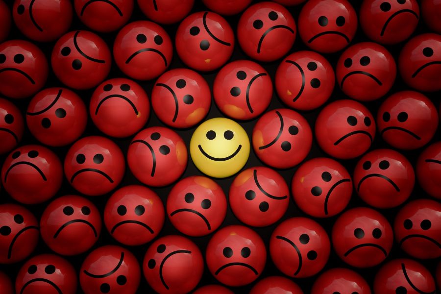 Happy and sad funny face ball character in crowd 