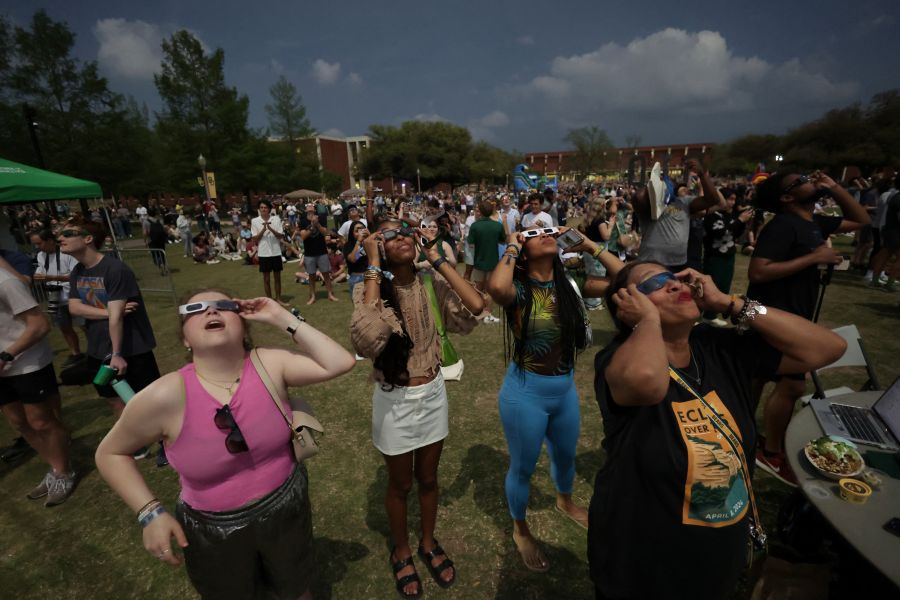 Baylor University students wearing protective glasses on Fountain Mall viewing the April 10, 2024 Total Solar Eclipse together.