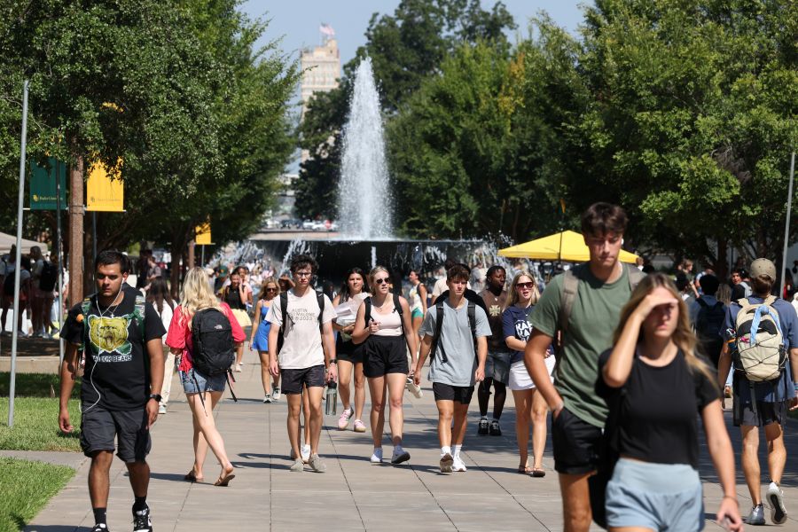 Baylor University students walk to classes on Fifth Street with Rosenbalm Fountain in the background.