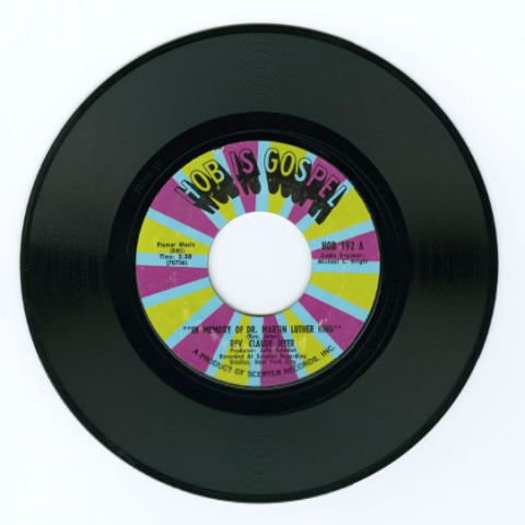 A 45 RPM record with a purple, blue and yellow label