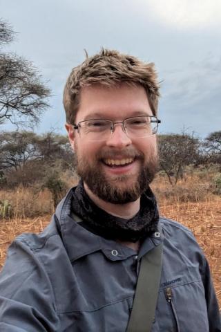 photo of Duncan Stibbard Hawkes, Ph.D. in bush