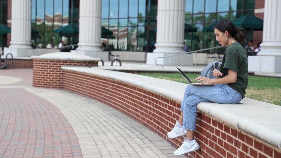 Student studying outside of BSB on Baylor Campus