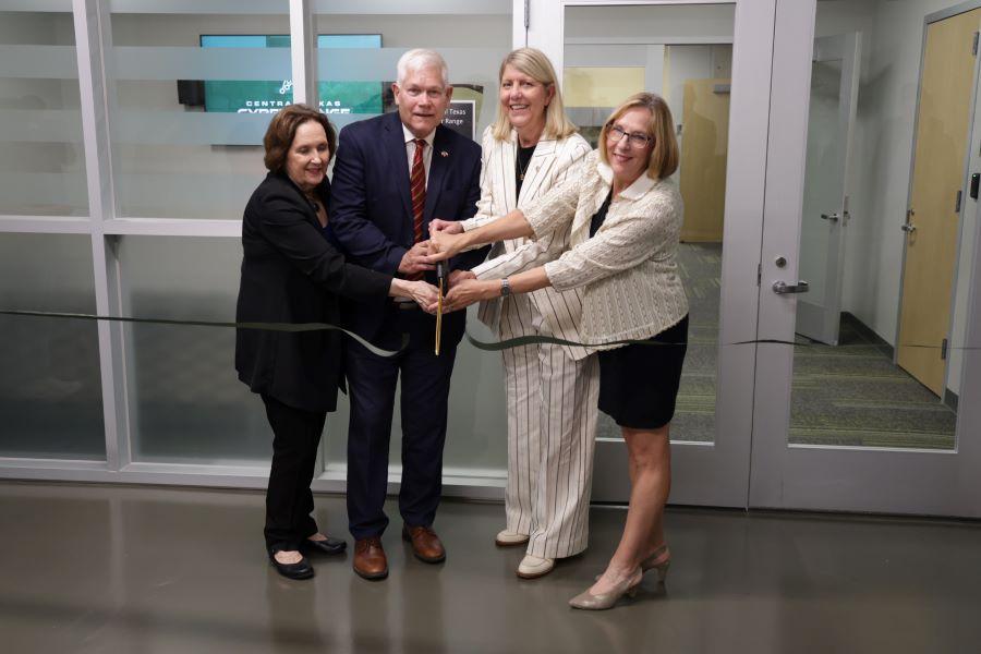L to R: McLennan Community College President Johnette McKown, Ed.D., Congressman Pete Sessions, Baylor President Linda A. Livingstone, Ph.D., and Baylor Provost Nancy Brickhouse, Ph.D. , celebrate the grand opening of the Central Texas Cyber Range with a ribbon-cutting.