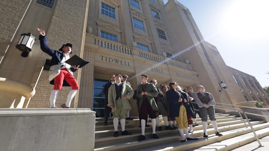 Dr. Julie Sweet leads her students in a reenactment of the Boston Tea Party. 