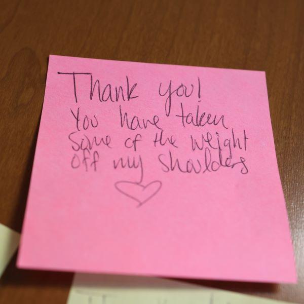 A pink post-it note expresses a student's thankfulness for The Store food pantry