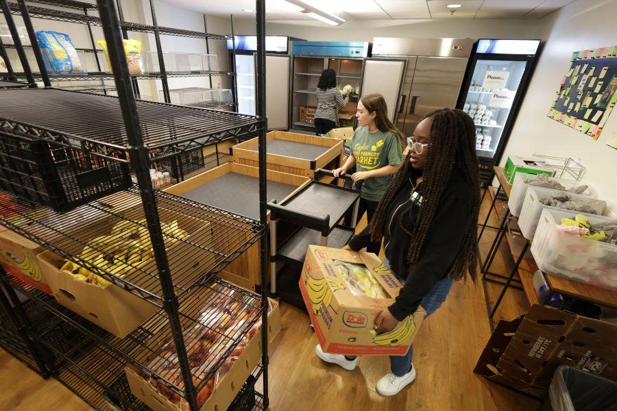 Staff stock fresh food at The Store food pantry on the Baylor campus