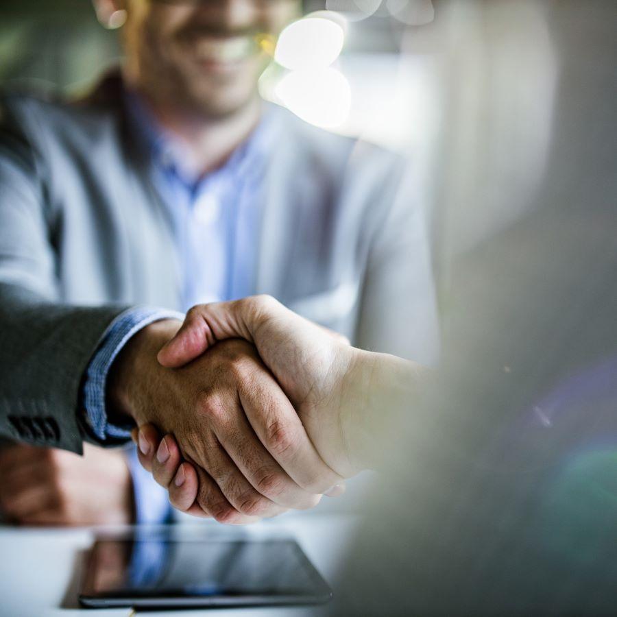 Close up of businessmen came to an agreement in the office.