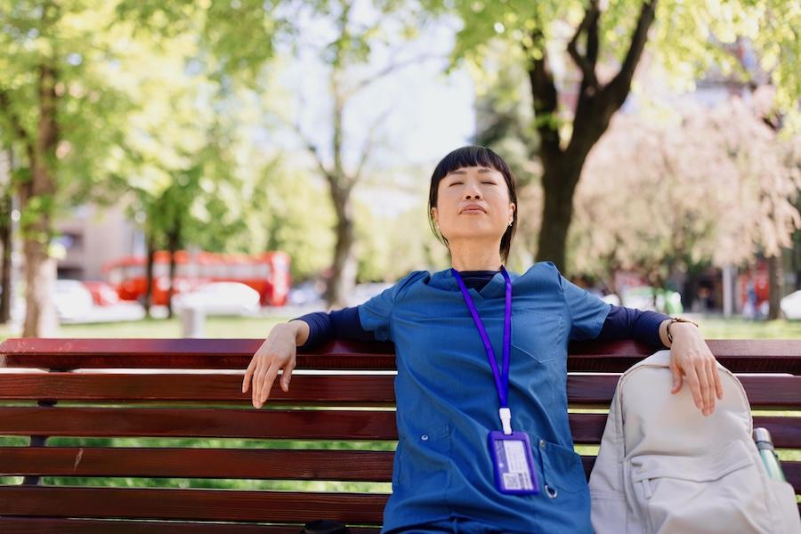 female nurse relaxing on bench