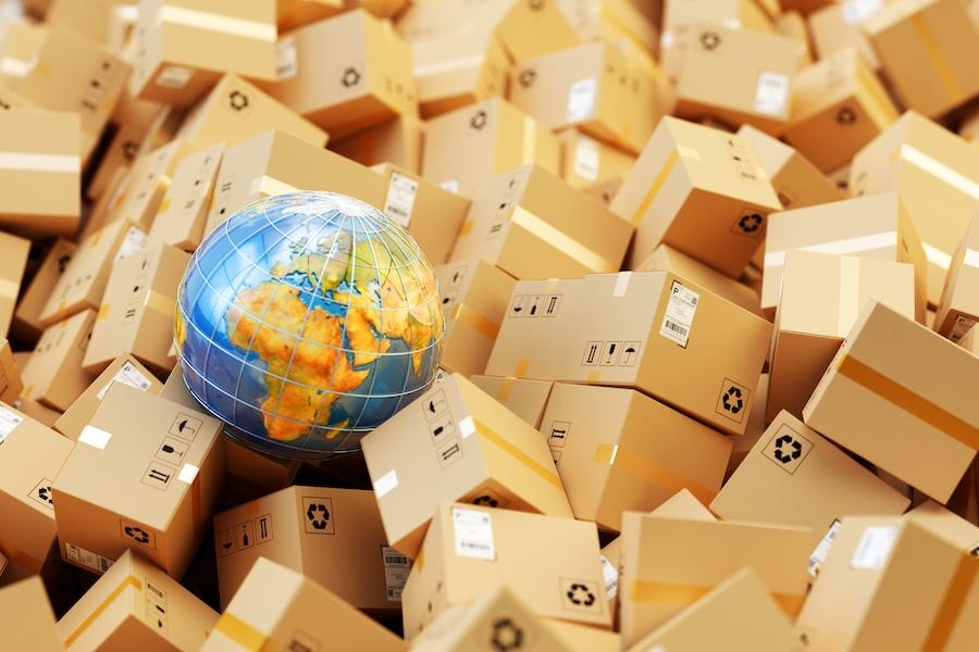 global sitting among shipping boxes