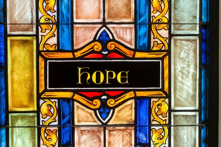The word Hope in colorful stained glass.