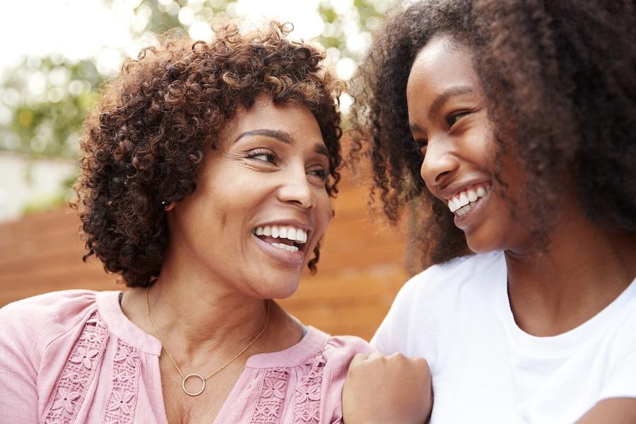 Mom and daughter looking at each other and smiling