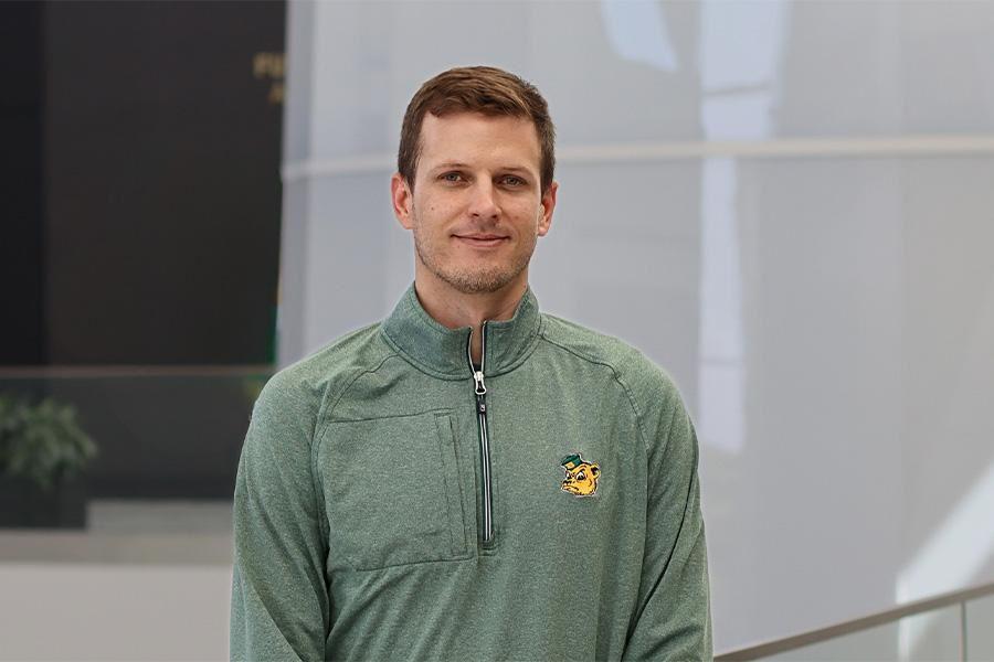 Dr. Paul Putz in a green pullover with a sailor bear logo