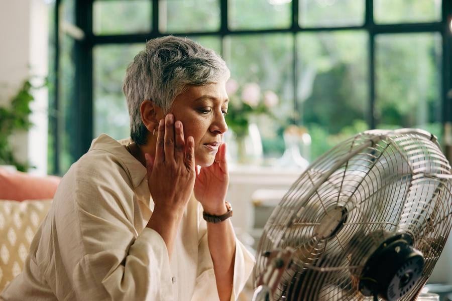 woman in front of fan to relief hot flash