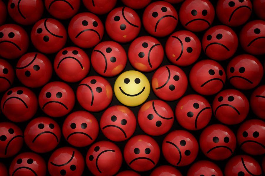 Happy and sad funny face ball character in crowd 