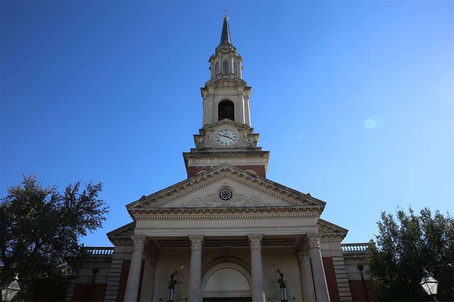 Looking up at the steeple and clock at the front of Park Cities Baptist Church in Dallas, Texas.