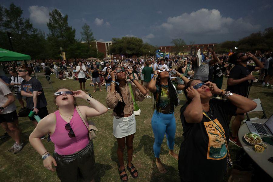 Baylor University students wearing protective glasses on Fountain Mall viewing the April 10, 2024 Total Solar Eclipse together.