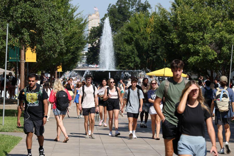 Baylor University students walk to classes on Fifth Street with Rosenbalm Fountain in the background.